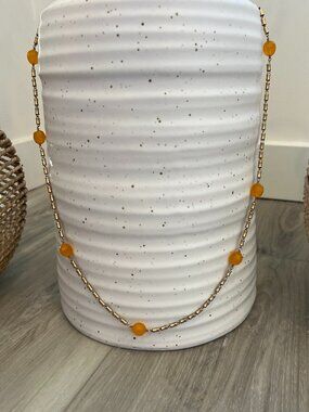 Gold station chain necklace adorned with orange Carnelian gemstones